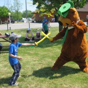 Yogi Bear and a child play fighting with swords