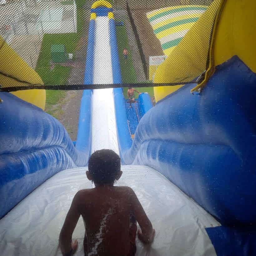 kid going down large waterslide