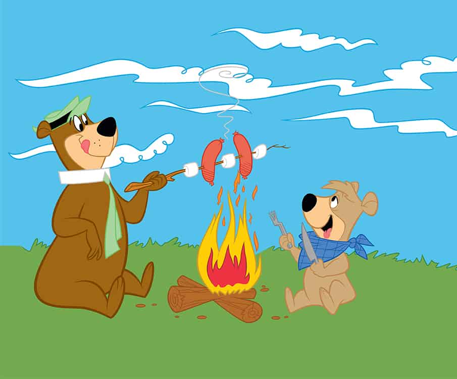 Yogi Bear and Boo boo cooking hot dogs over a campfire
