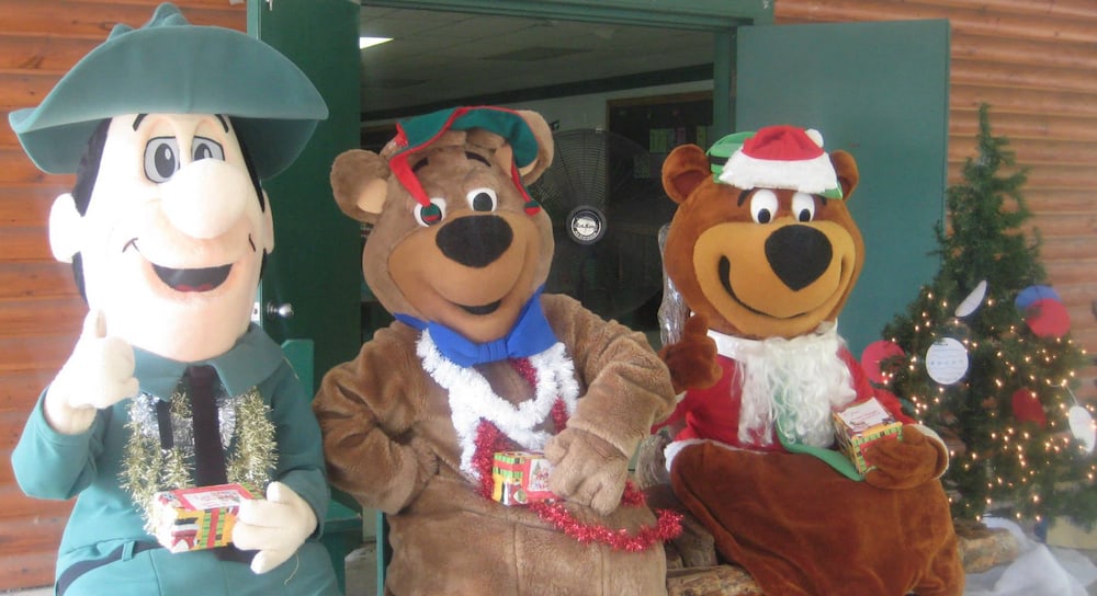 Yogi Bear dressed as Santa with Ranger Smith