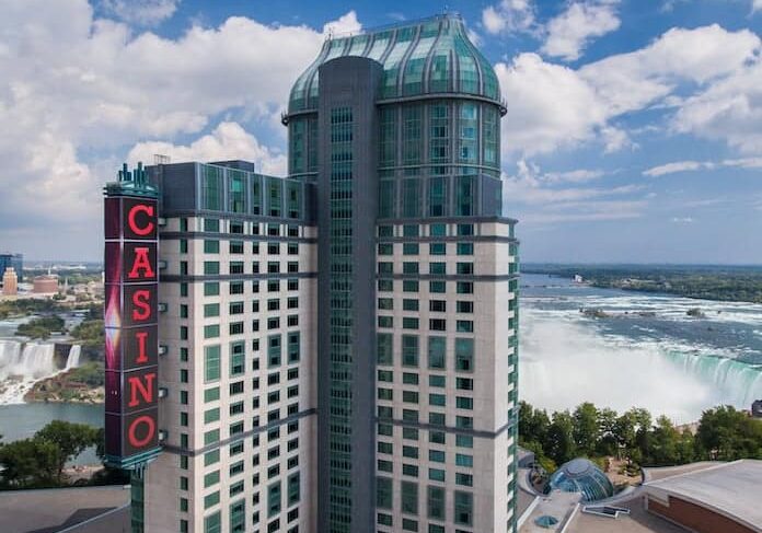 aerial view of Fallsview Casino Resort building with Niagara Falls behind it